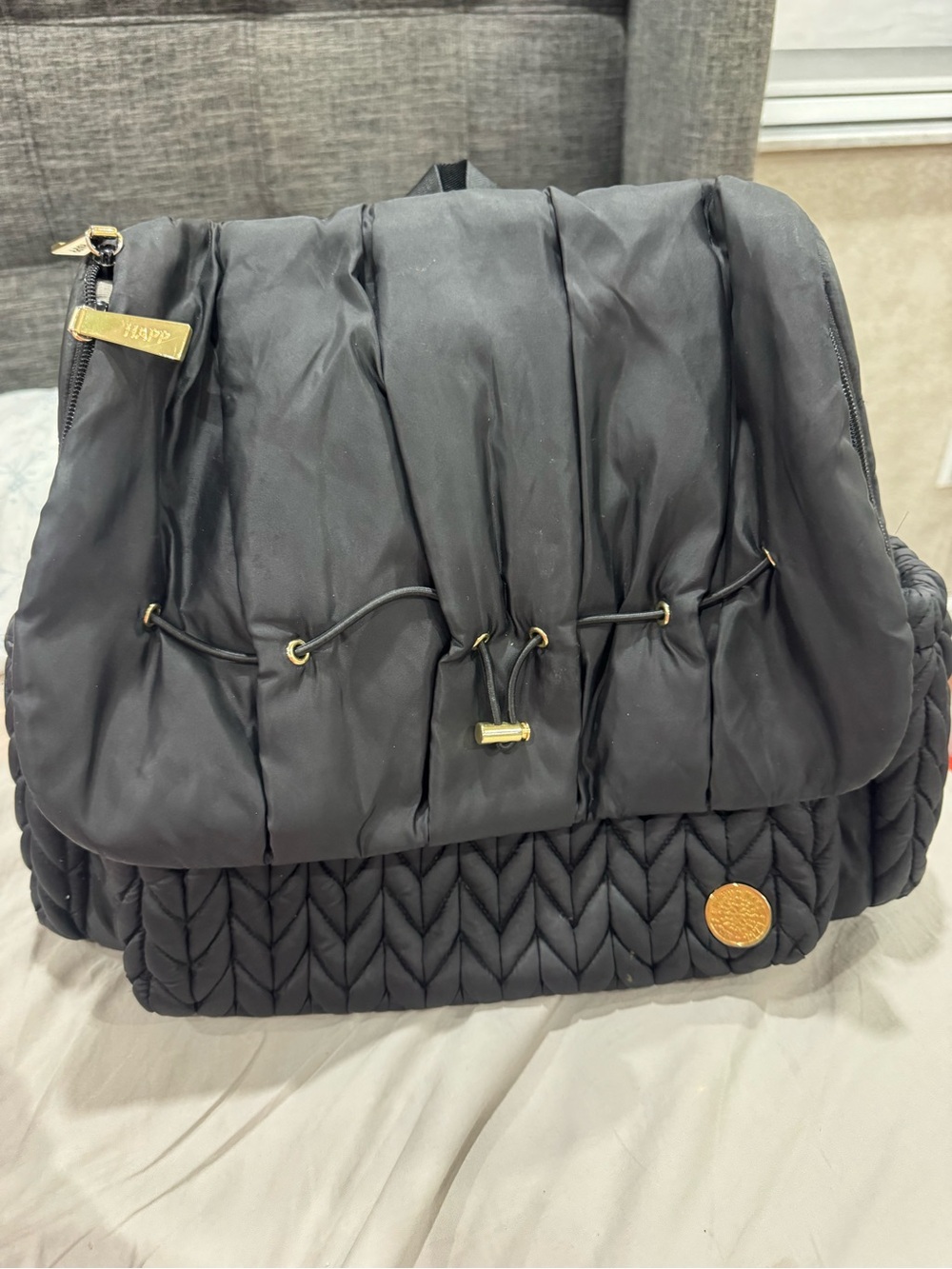 Quilted Black Drawstring Baby Backpack with Gold Accents